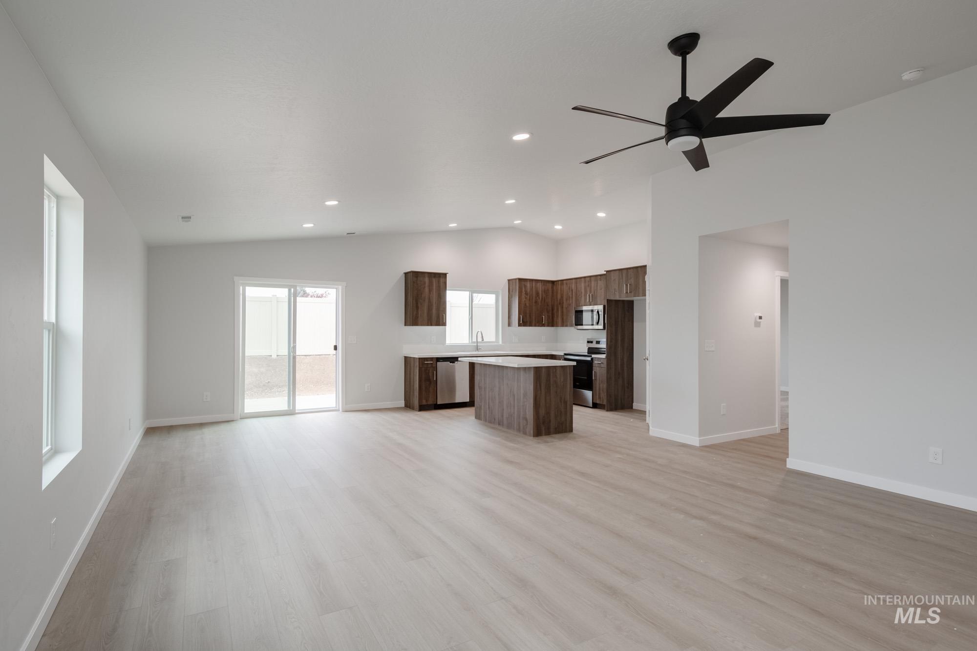 13736 Nisene Street Caldwell, ID 83607 - Photo 22 of 22 Kitchen featuring open floor plan, light countertops, a center island, vaulted ceiling, and light wood-style flooring