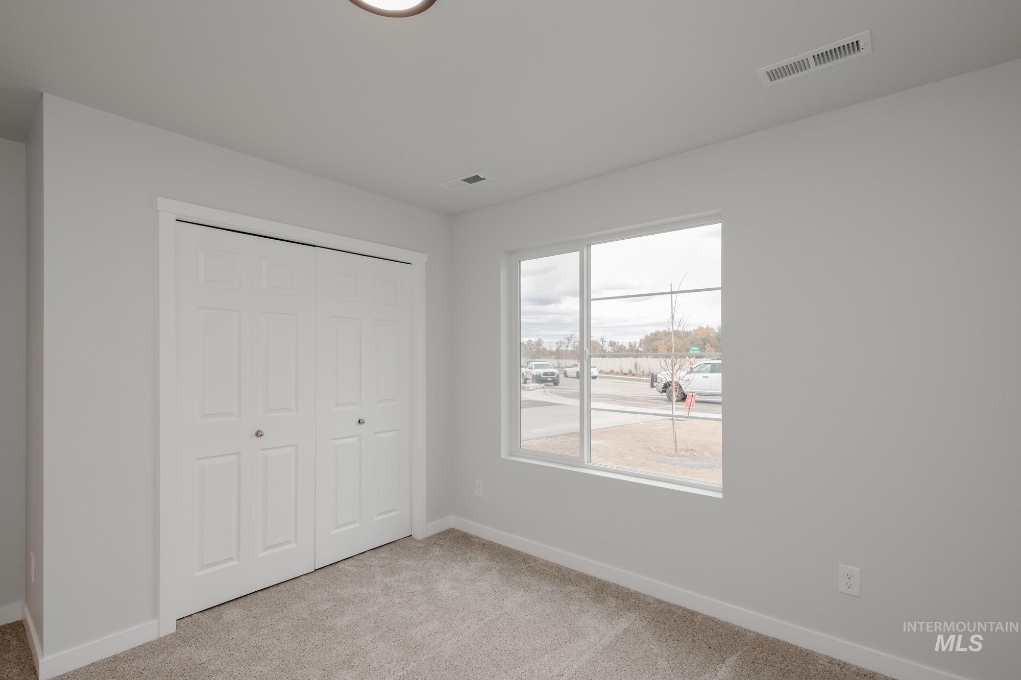 13736 Nisene Street Caldwell, ID 83607 - Photo 11 of 22 Unfurnished bedroom featuring light colored carpet and a closet