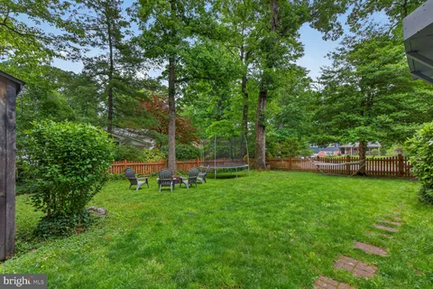 a view of a house with a yard and deck