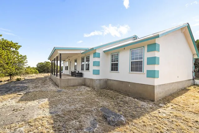 a view of a house with a backyard