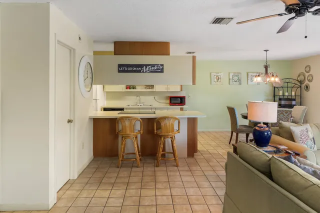 a dining room with furniture and a chandelier