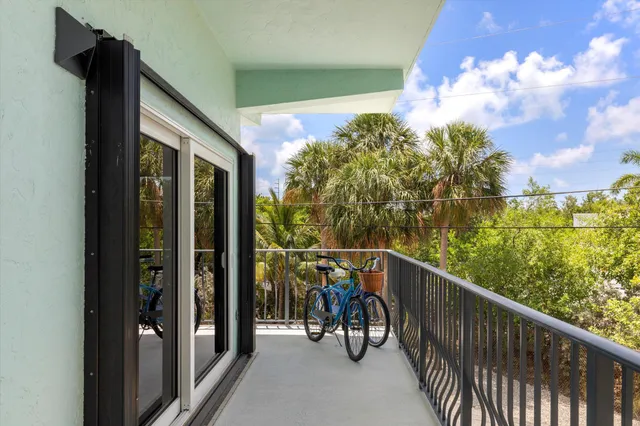 a view of a porch with wooden floor and fence