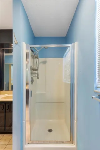 a bathroom with a glass shower door