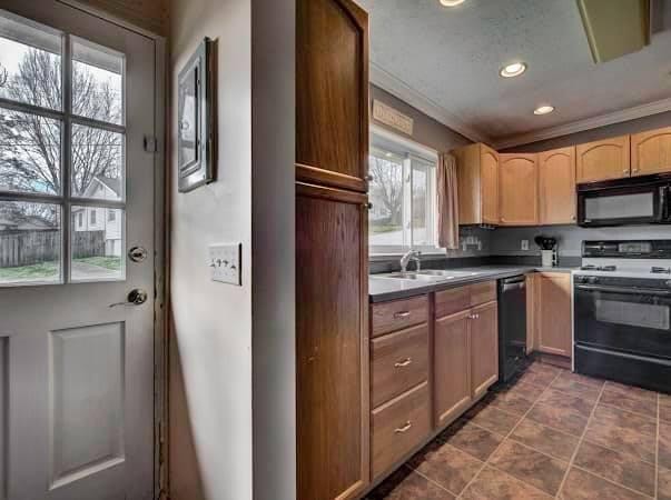 108 Powell Road Oak Ridge, TN 37830 - Photo 2 of 7 a kitchen with granite countertop a refrigerator and a stove top oven