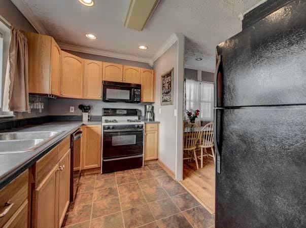 108 Powell Road Oak Ridge, TN 37830 - Photo 3 of 7 a kitchen with granite countertop a refrigerator and a stove top oven