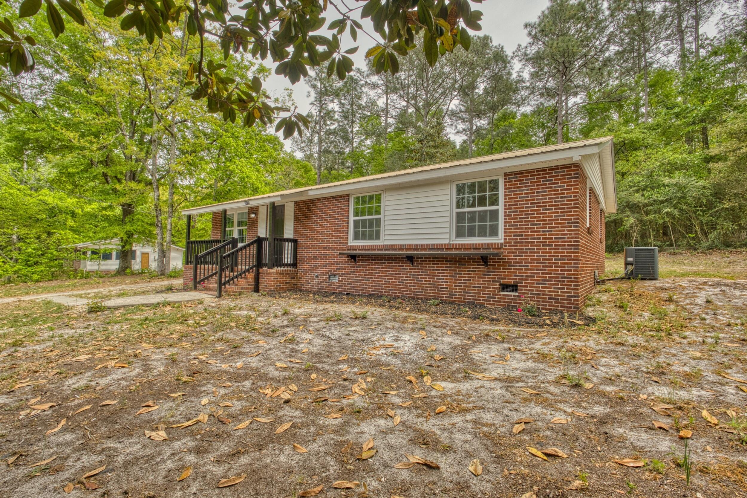 3016 Wagener Road Aiken, SC 29801 - Photo 4 of 29 a backyard of a house with plants and large trees