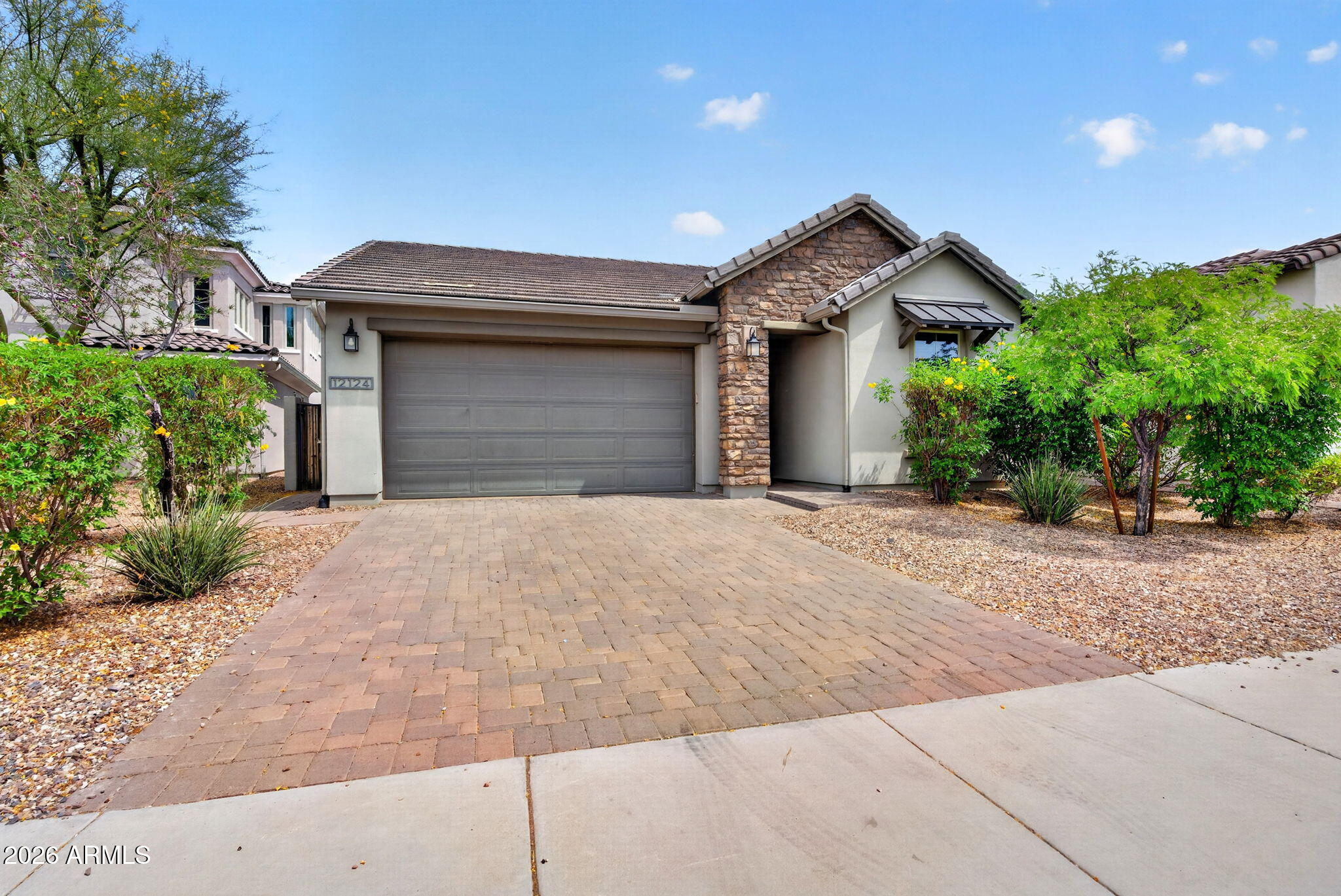 12124 West Peak View Road Peoria, AZ 85383 - Photo 1 of 38 a front view of a house with a yard and garage