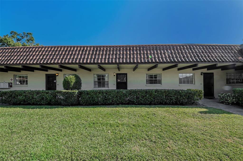 1701 Pinehurst Road, Unit 4F Dunedin, FL 34698 - Photo 14 of 56 a front view of a house with garden