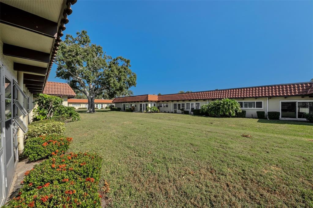 1701 Pinehurst Road, Unit 4F Dunedin, FL 34698 - Photo 2 of 56 a view of a house with a yard