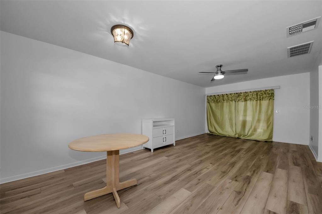 1701 Pinehurst Road, Unit 4F Dunedin, FL 34698 - Photo 23 of 56 a view of an empty room with wooden floor and a window