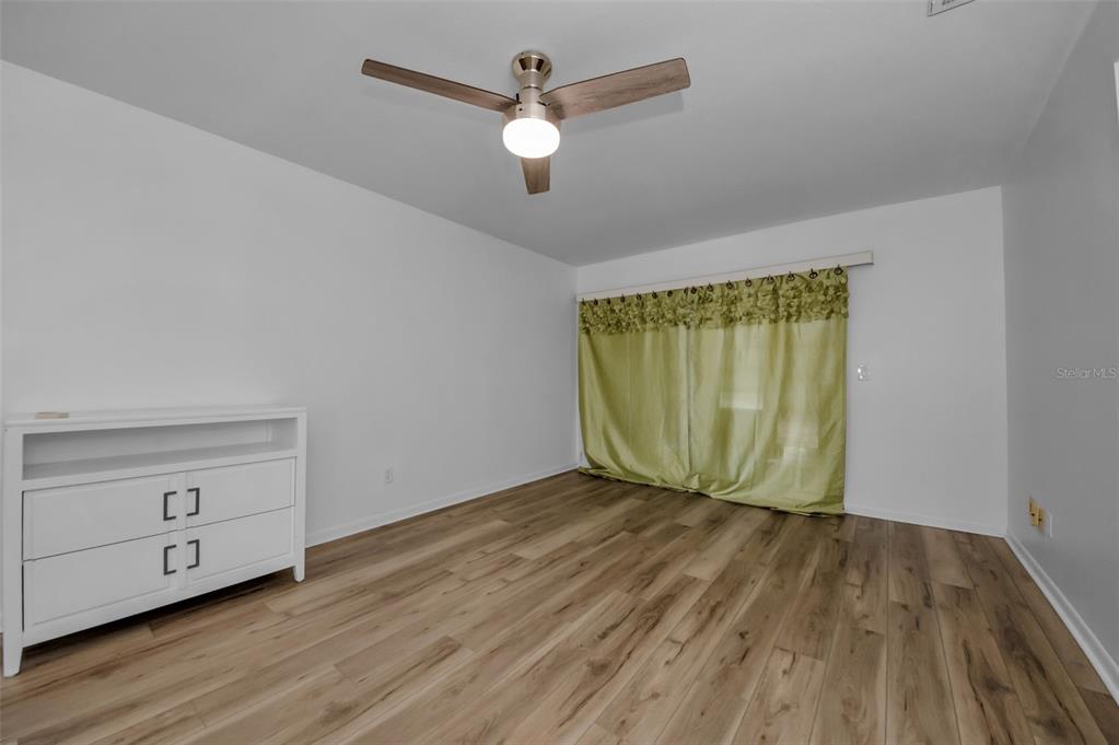 1701 Pinehurst Road, Unit 4F Dunedin, FL 34698 - Photo 24 of 56 wooden floor in an empty room with a window