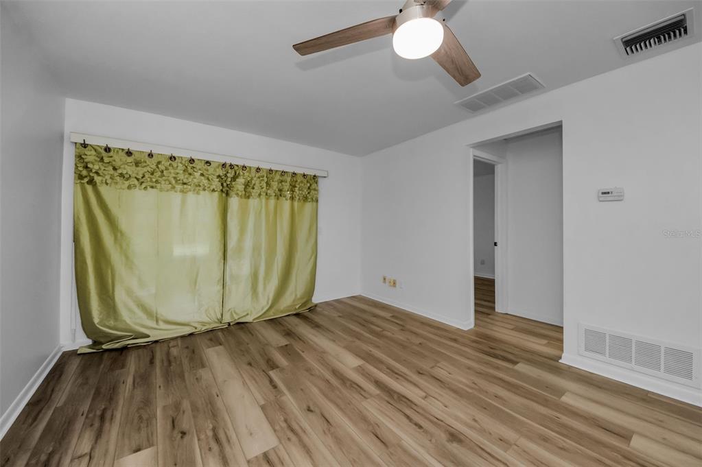 1701 Pinehurst Road, Unit 4F Dunedin, FL 34698 - Photo 25 of 56 a view of a room with wooden floor and door