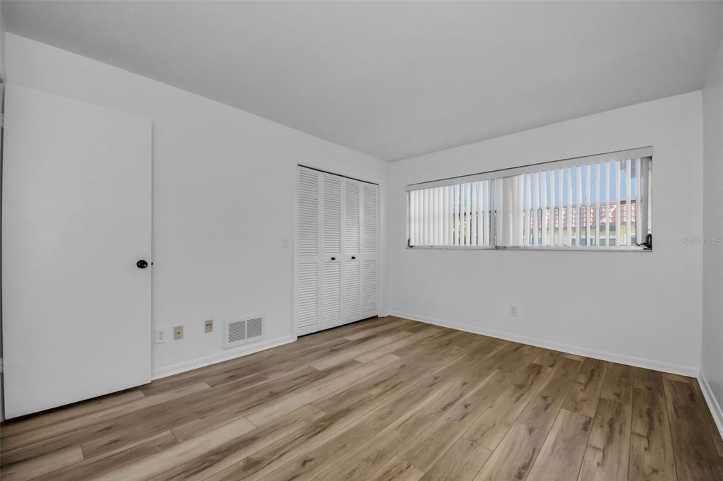1701 Pinehurst Road, Unit 4F Dunedin, FL 34698 - Photo 28 of 56 a view of empty room with wooden floor and fan