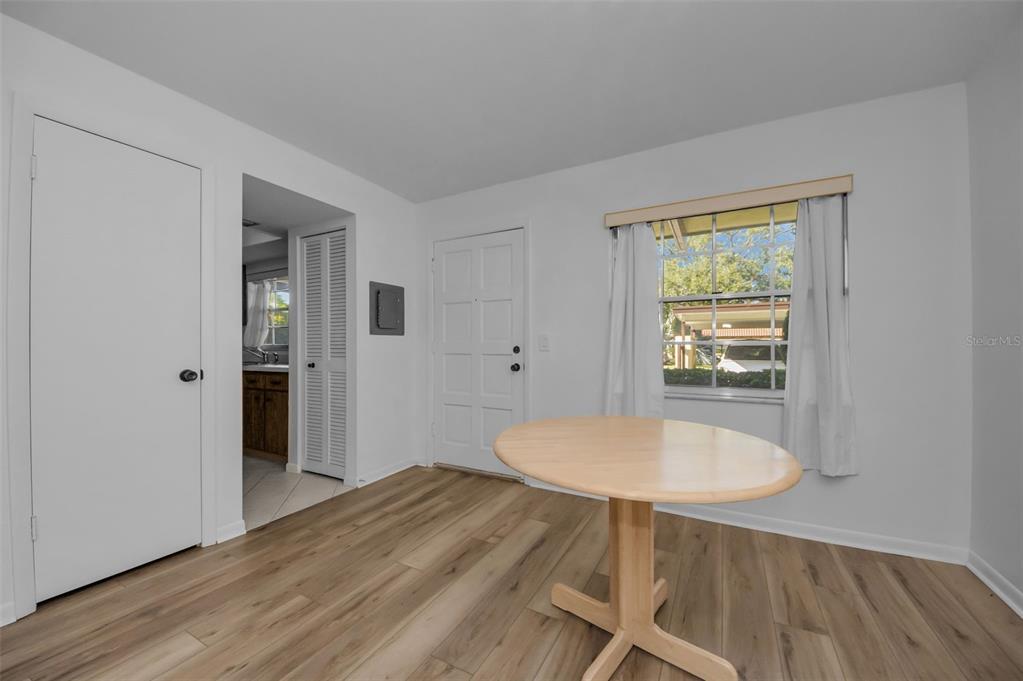 1701 Pinehurst Road, Unit 4F Dunedin, FL 34698 - Photo 3 of 56 a room with wooden floor and a table