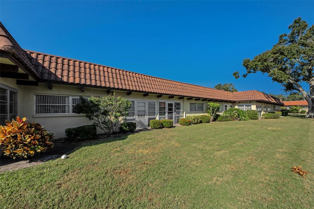 1701 Pinehurst Road, Unit 4F Dunedin, FL 34698 - Photo 32 of 56 a front view of a house with garden