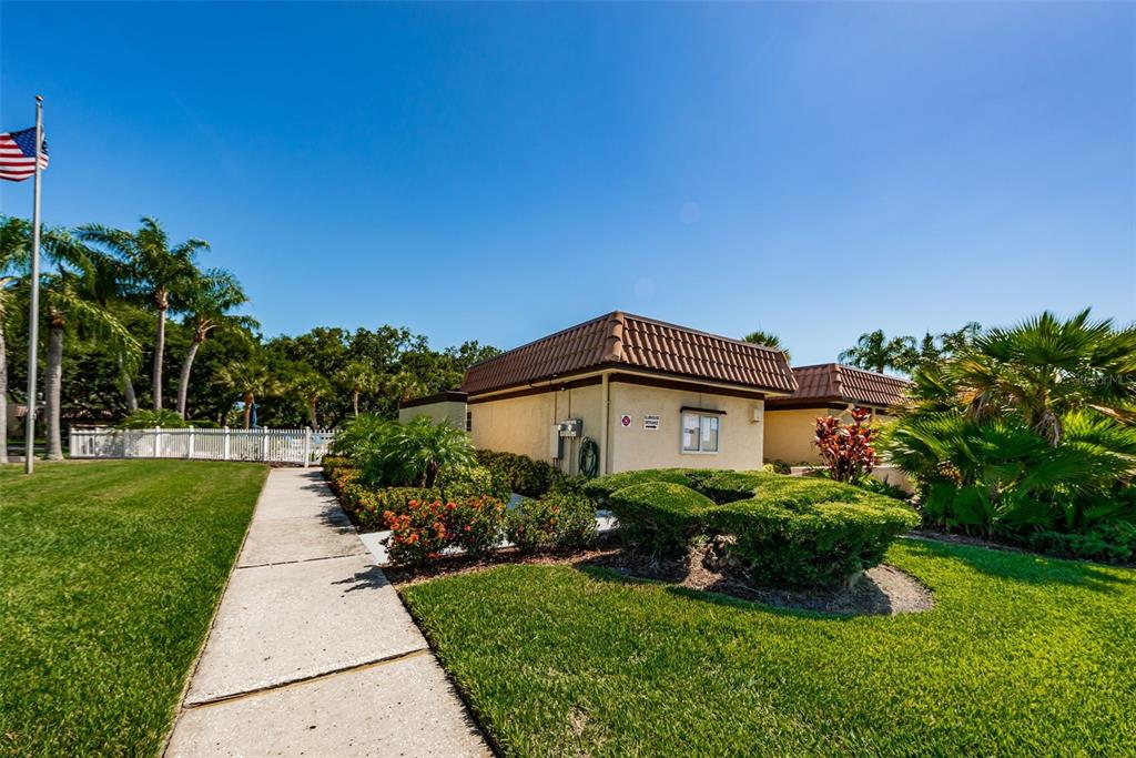 1701 Pinehurst Road, Unit 4F Dunedin, FL 34698 - Photo 34 of 56 a view of a house with a big yard plants and large trees