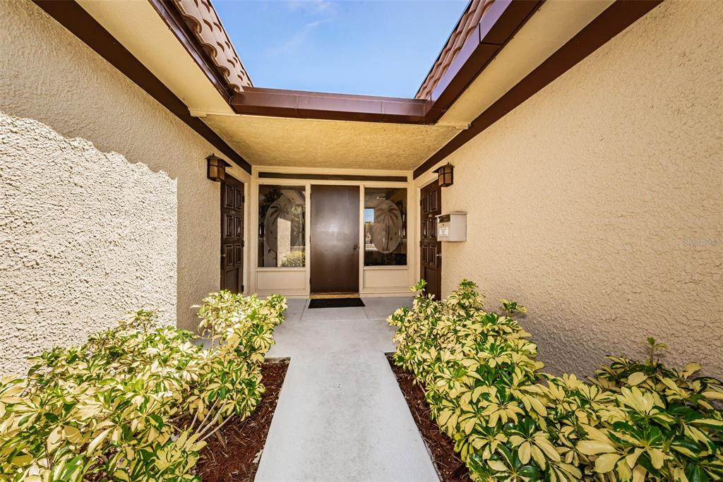1701 Pinehurst Road, Unit 4F Dunedin, FL 34698 - Photo 35 of 56 a front view of a house with a lot of flowers