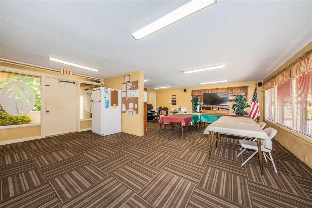 1701 Pinehurst Road, Unit 4F Dunedin, FL 34698 - Photo 37 of 56 a living room with furniture a window and a table