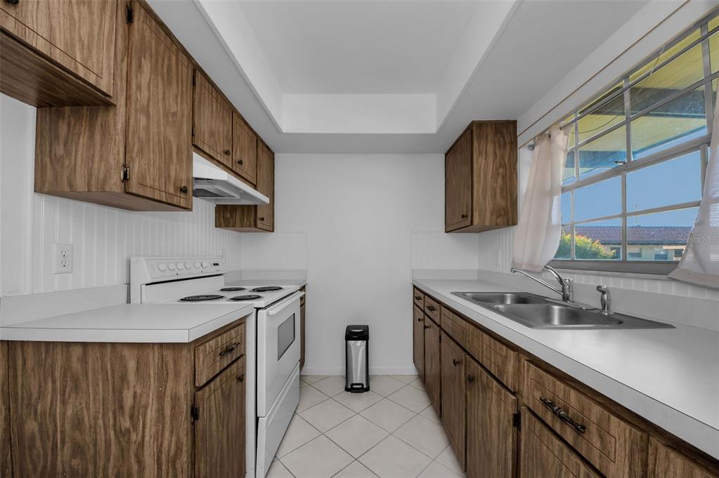 1701 Pinehurst Road, Unit 4F Dunedin, FL 34698 - Photo 4 of 56 a kitchen with stainless steel appliances a sink stove and cabinets