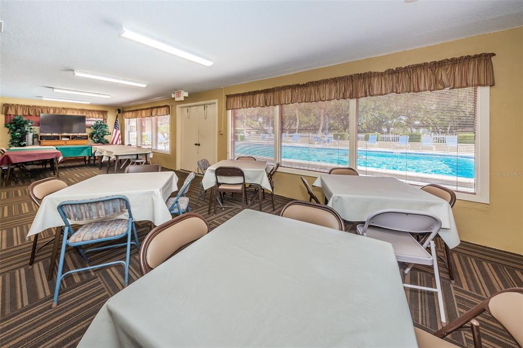 1701 Pinehurst Road, Unit 4F Dunedin, FL 34698 - Photo 41 of 56 a living room with furniture and a floor to ceiling window