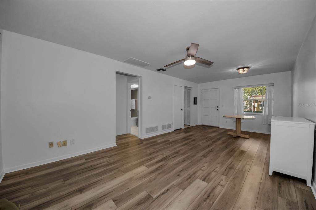 1701 Pinehurst Road, Unit 4F Dunedin, FL 34698 - Photo 5 of 56 wooden floor in an empty room with a window