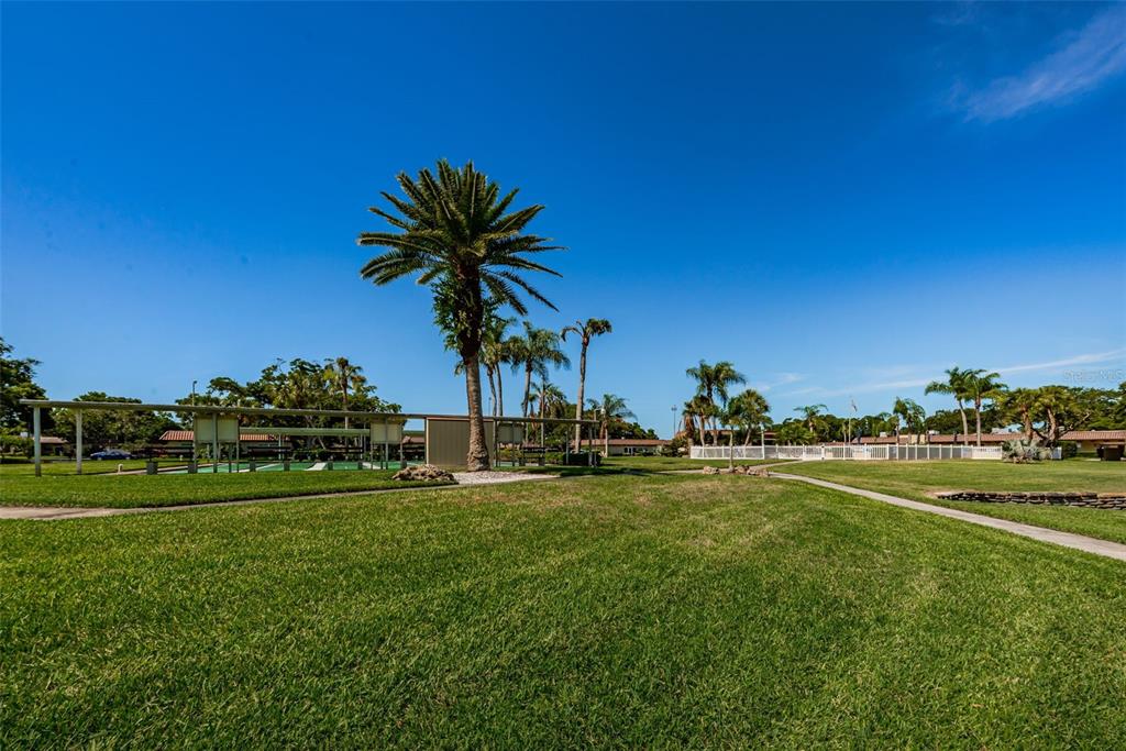 1701 Pinehurst Road, Unit 4F Dunedin, FL 34698 - Photo 53 of 56 a view of a golf course with a big yard