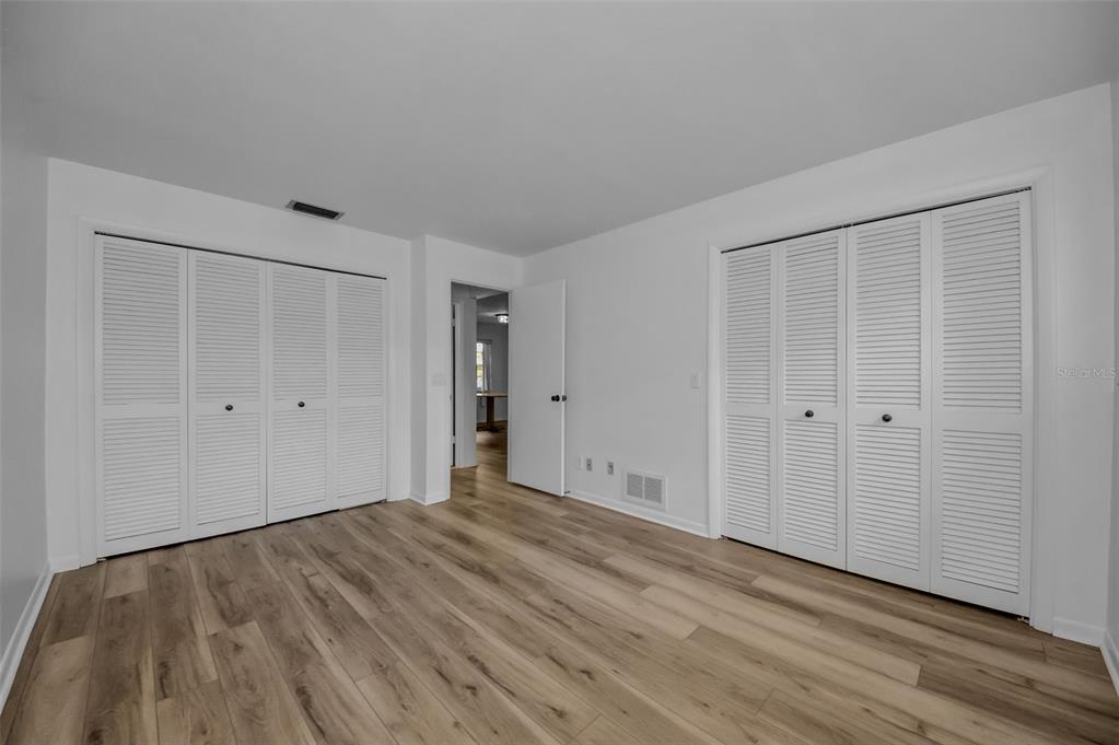 1701 Pinehurst Road, Unit 4F Dunedin, FL 34698 - Photo 6 of 56 a view of an empty room with wooden floor