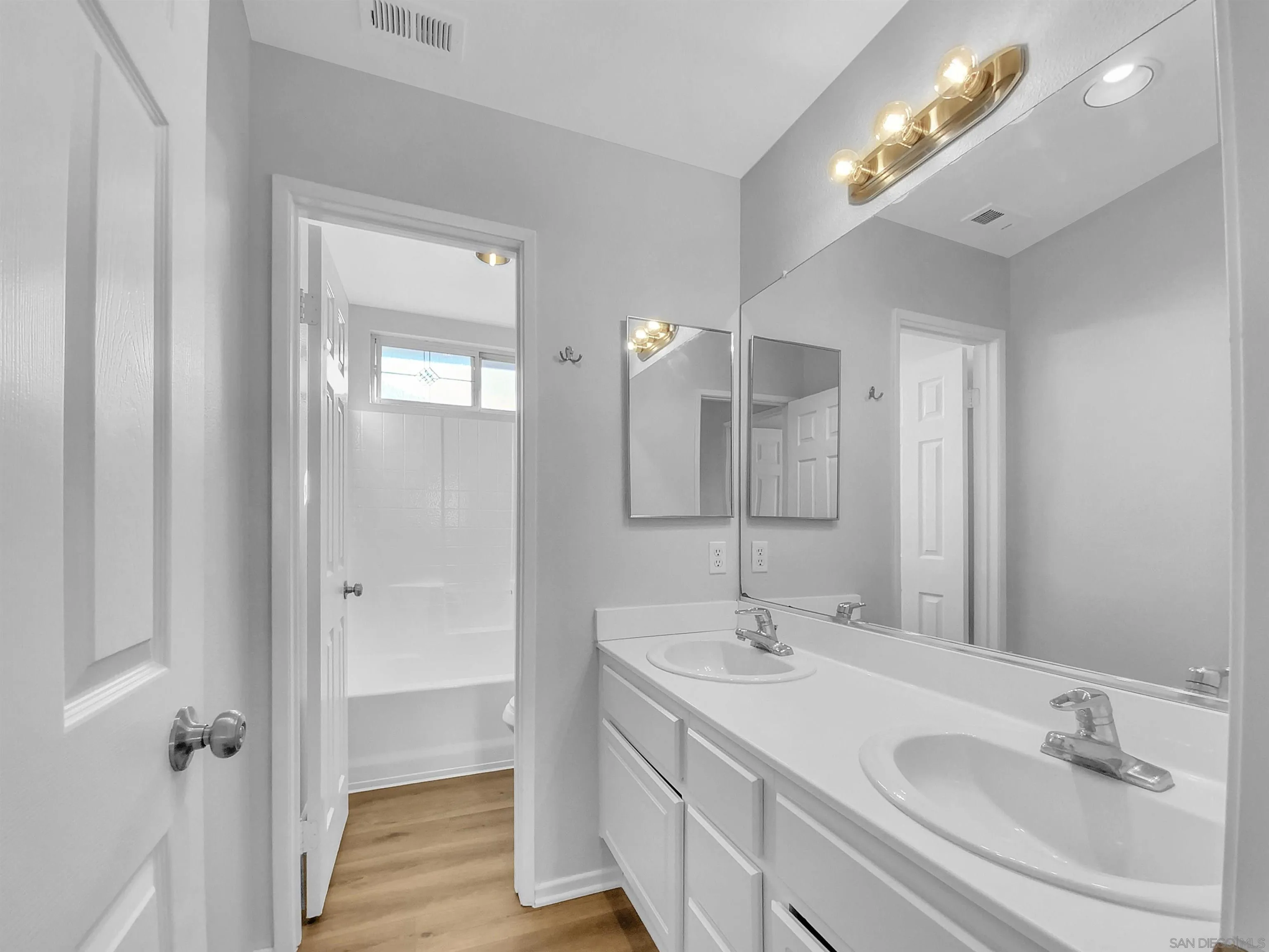 1272 Santa Lucia Road Chula Vista, CA 91913 - Photo 18 of 25 a bathroom with a double vanity sink and a mirror