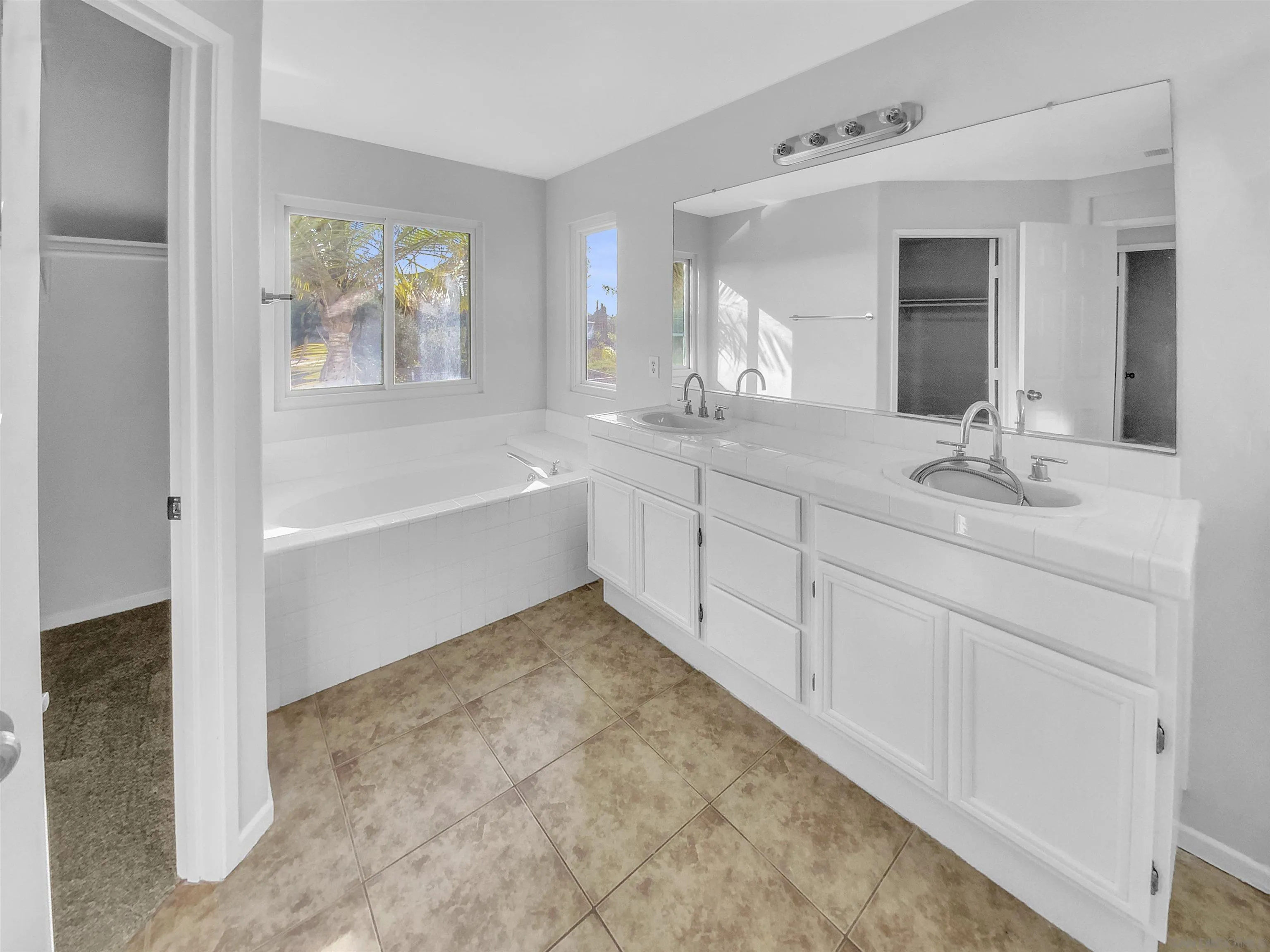 1272 Santa Lucia Road Chula Vista, CA 91913 - Photo 21 of 25 a spacious bathroom with a sink tub and a mirror
