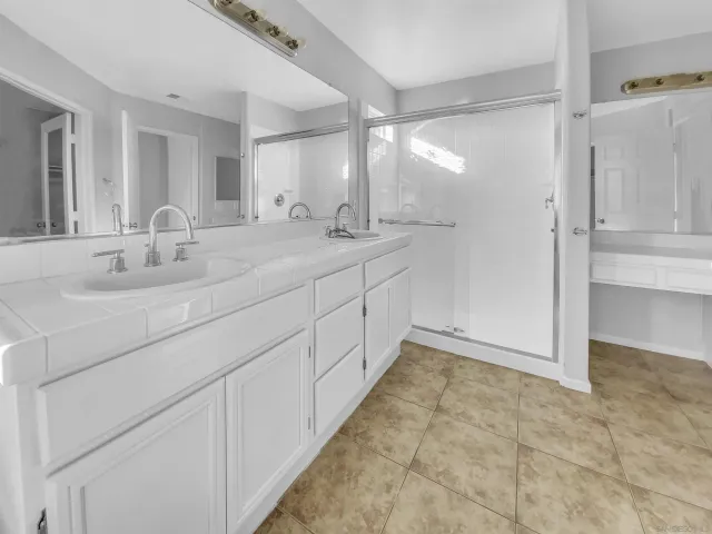 a bathroom with a double vanity sink and a mirror