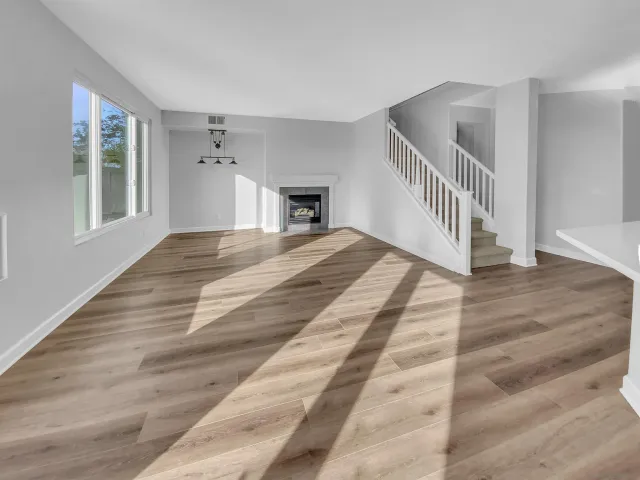 a kitchen with stainless steel appliances granite countertop a refrigerator a stove and a wooden floors