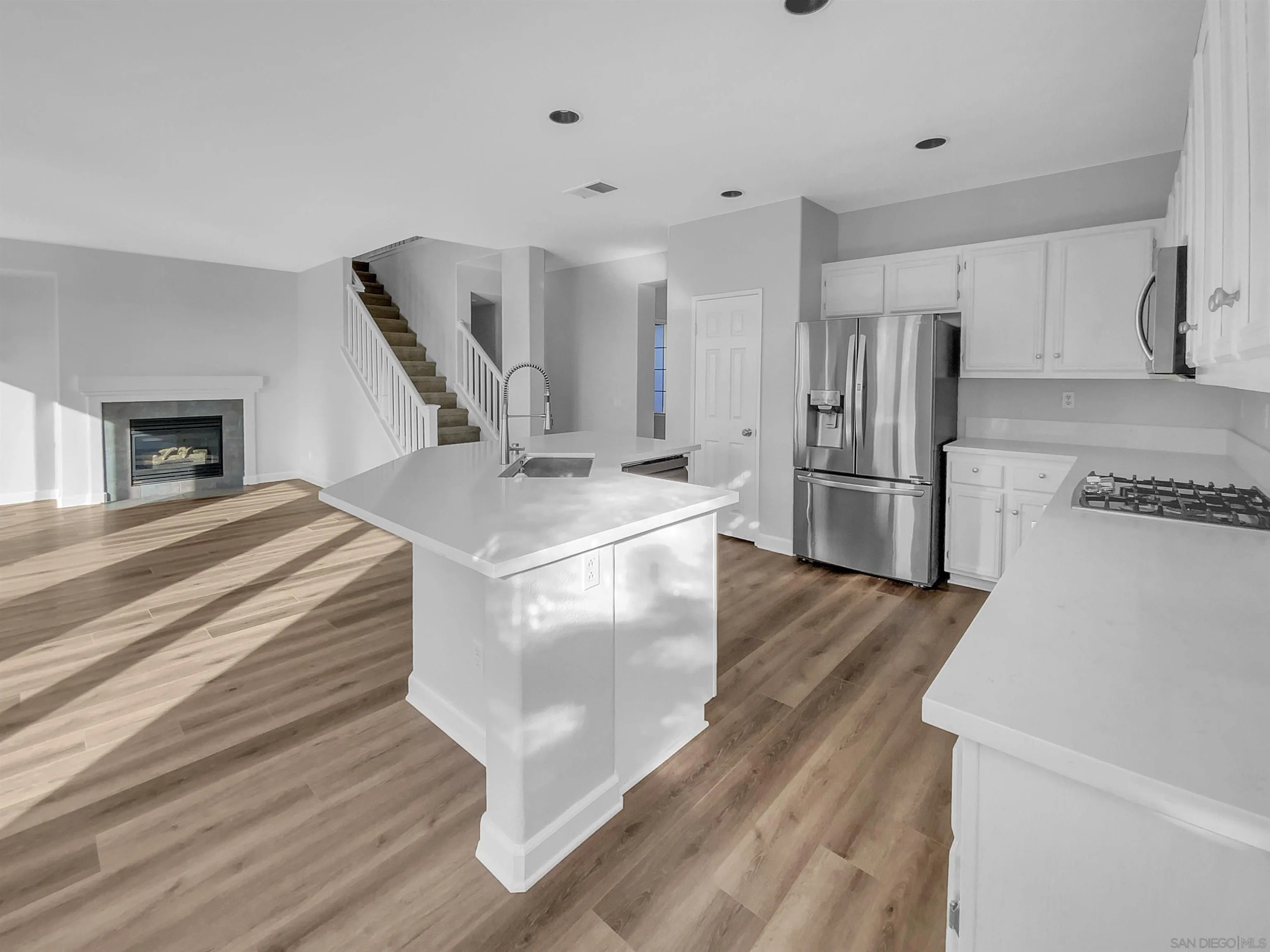 1272 Santa Lucia Road Chula Vista, CA 91913 - Photo 10 of 25 a kitchen with stainless steel appliances granite countertop a refrigerator a stove and a wooden floors