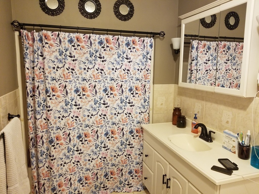 18 Mott Street Fall River, MA 02721 - Photo 11 of 27 a bathroom with a sink and a shower curtain