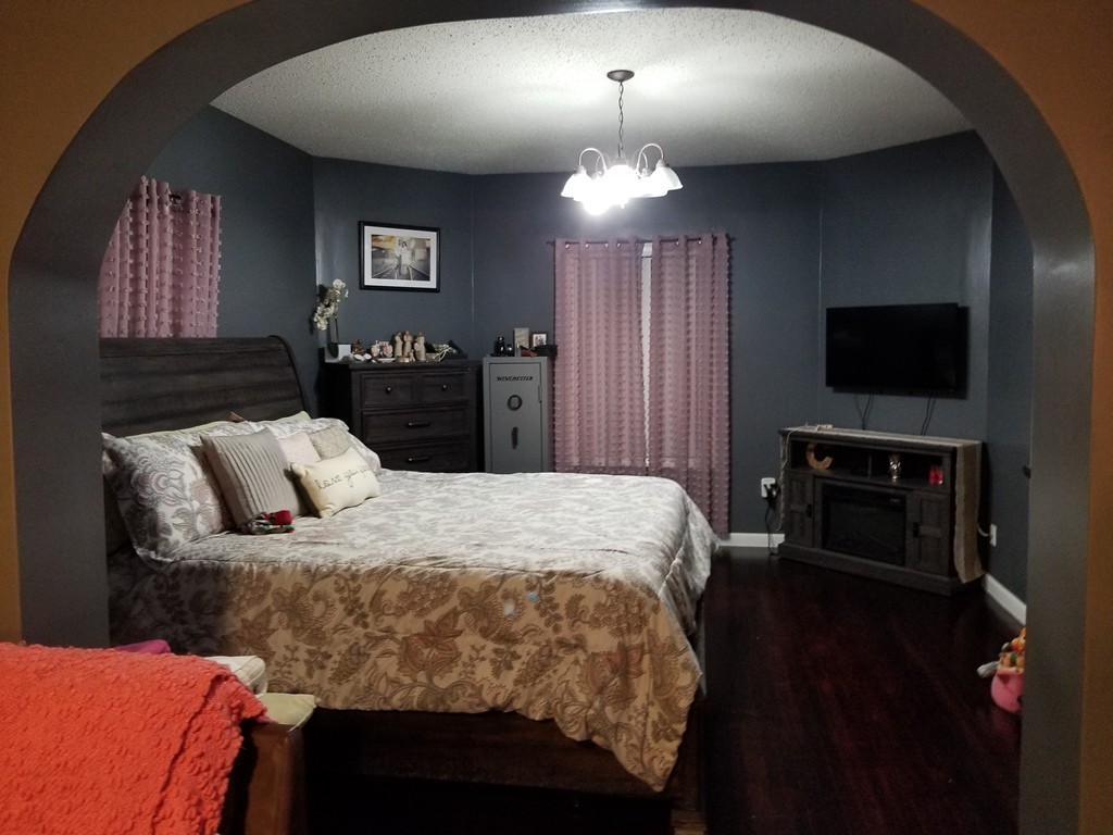 18 Mott Street Fall River, MA 02721 - Photo 14 of 27 a bed sitting in a bedroom and a flat tv screen on dresser