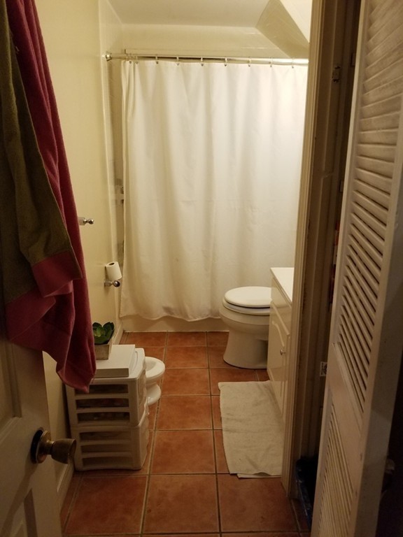 18 Mott Street Fall River, MA 02721 - Photo 18 of 27 a bathroom with a toilet and a shower curtain