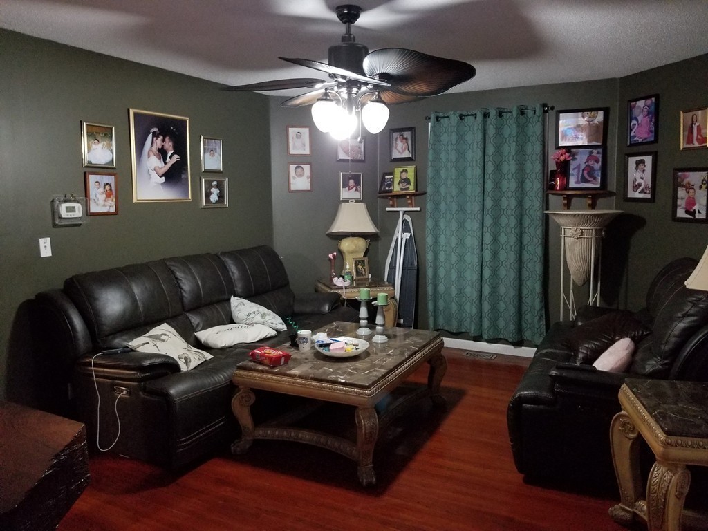 18 Mott Street Fall River, MA 02721 - Photo 5 of 27 a living room with furniture and a chandelier