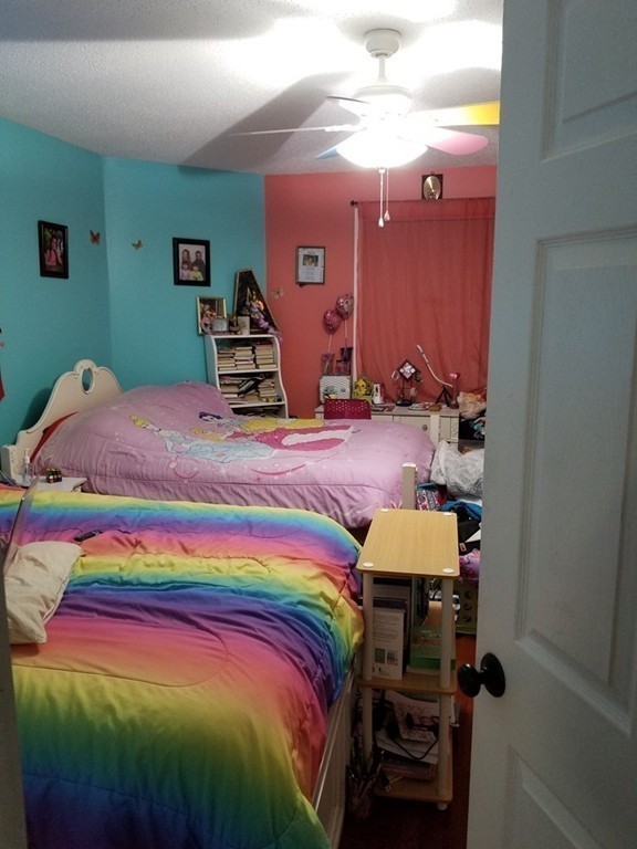 18 Mott Street Fall River, MA 02721 - Photo 7 of 27 a bedroom with a bed and a lamp on dresser