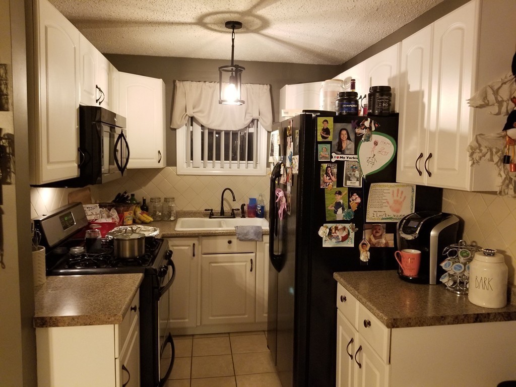 18 Mott Street Fall River, MA 02721 - Photo 10 of 27 a kitchen with lots of appliances and cabinets