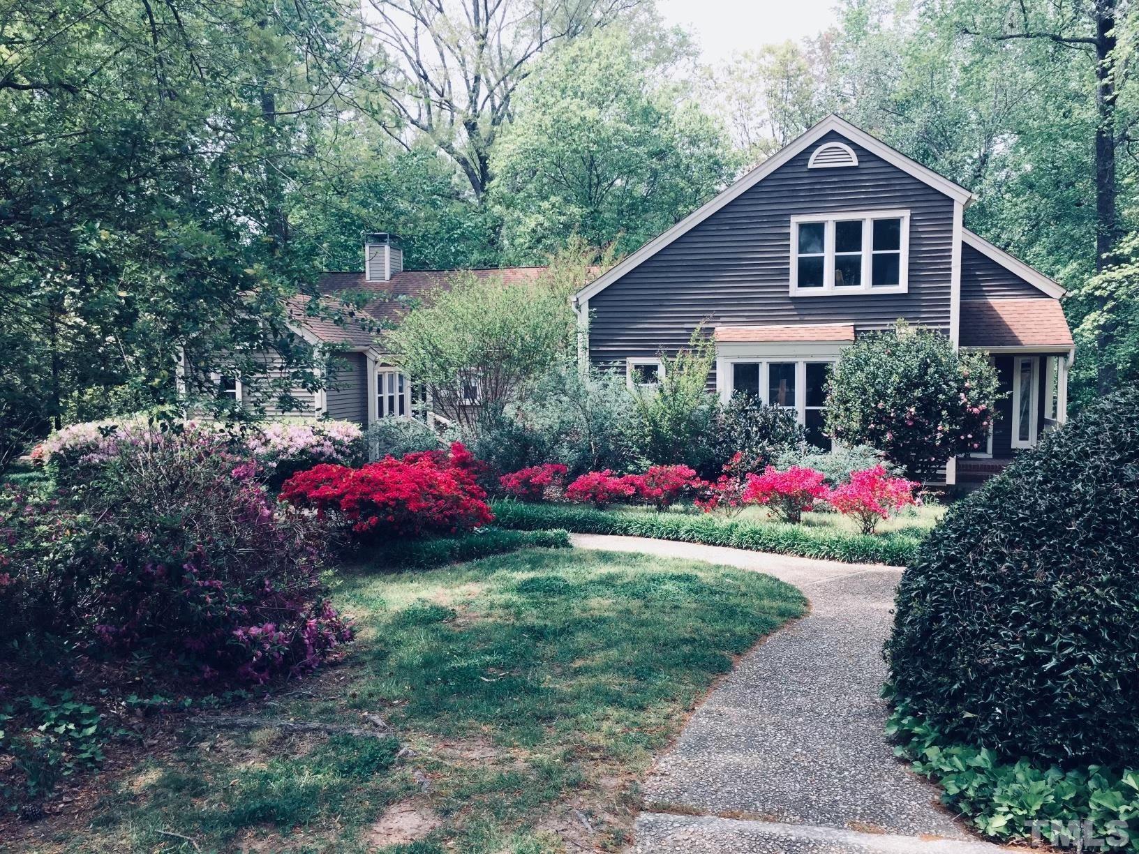 5811 Sentinel Drive Raleigh, NC 27609 - Photo 1 of 20 a view of a house with a yard and a garden