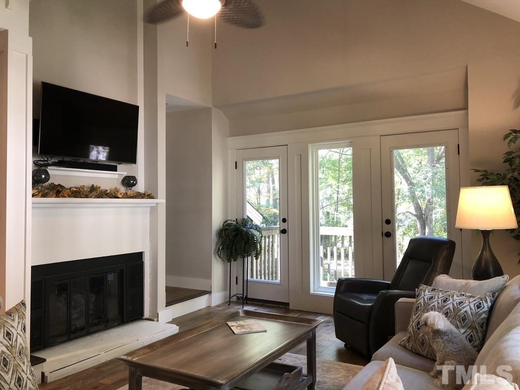 5811 Sentinel Drive Raleigh, NC 27609 - Photo 14 of 20 a living room with furniture a flat screen tv and a fireplace