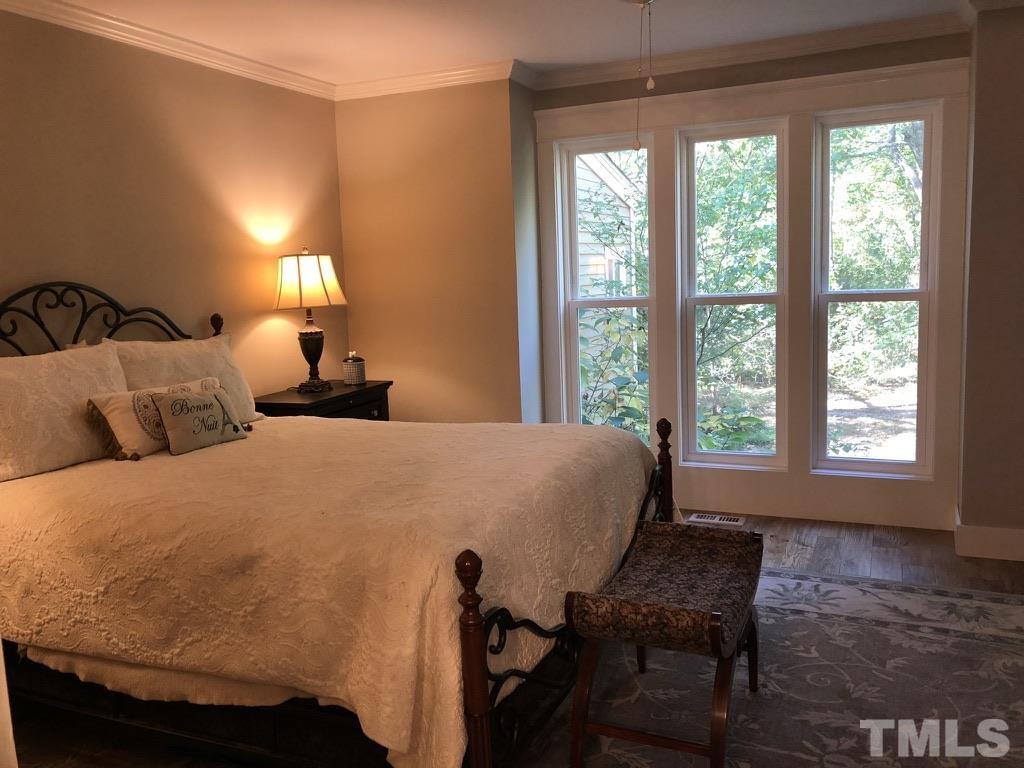 5811 Sentinel Drive Raleigh, NC 27609 - Photo 19 of 20 a bed sitting in a bedroom next to a window