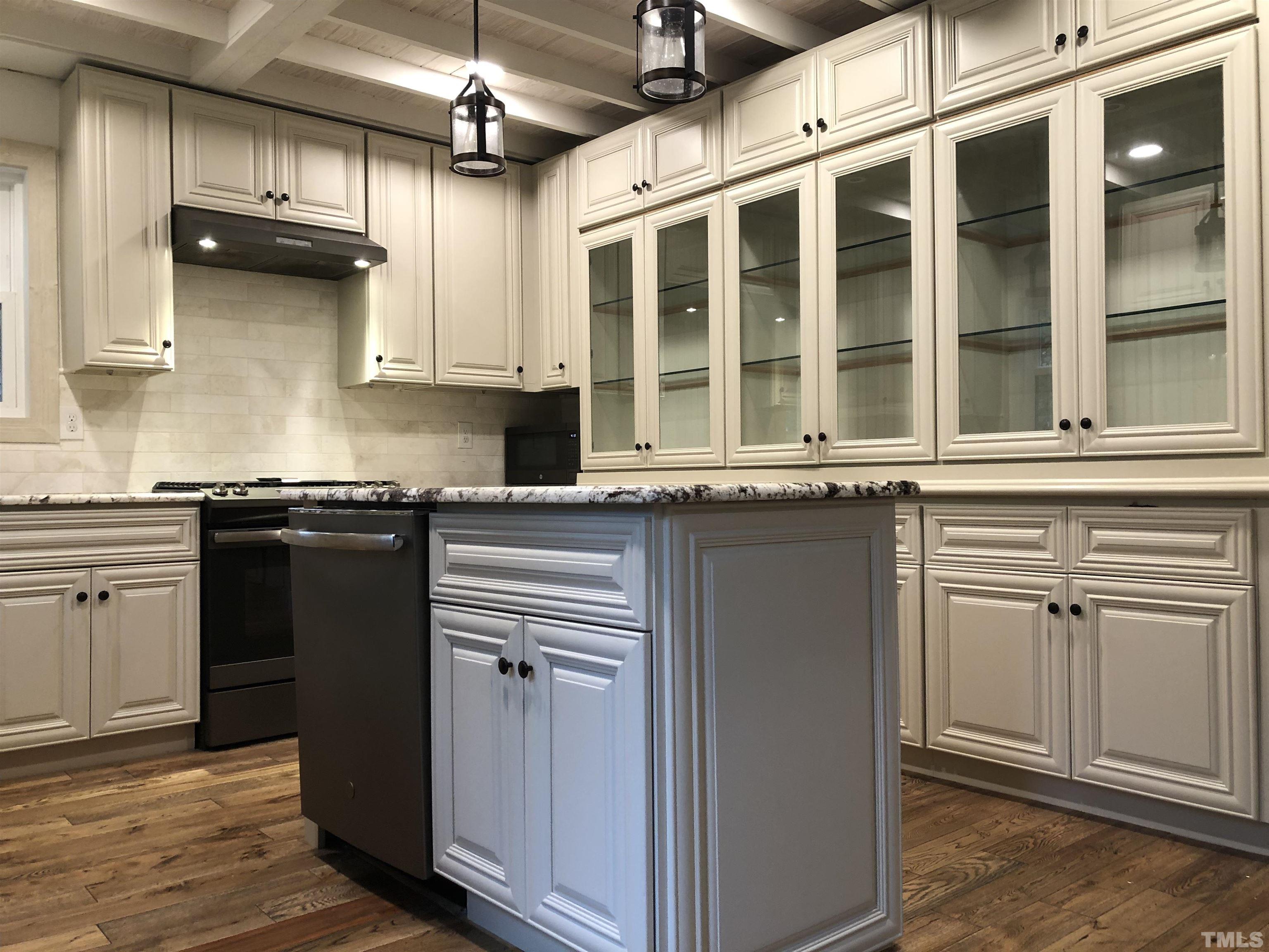 5811 Sentinel Drive Raleigh, NC 27609 - Photo 3 of 20 a kitchen with stainless steel appliances granite countertop a sink and a stove