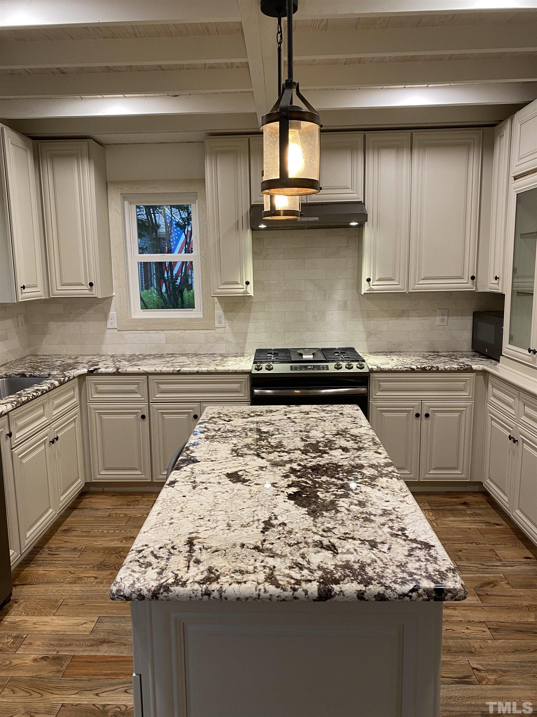 5811 Sentinel Drive Raleigh, NC 27609 - Photo 4 of 20 a kitchen with a sink stove and cabinets