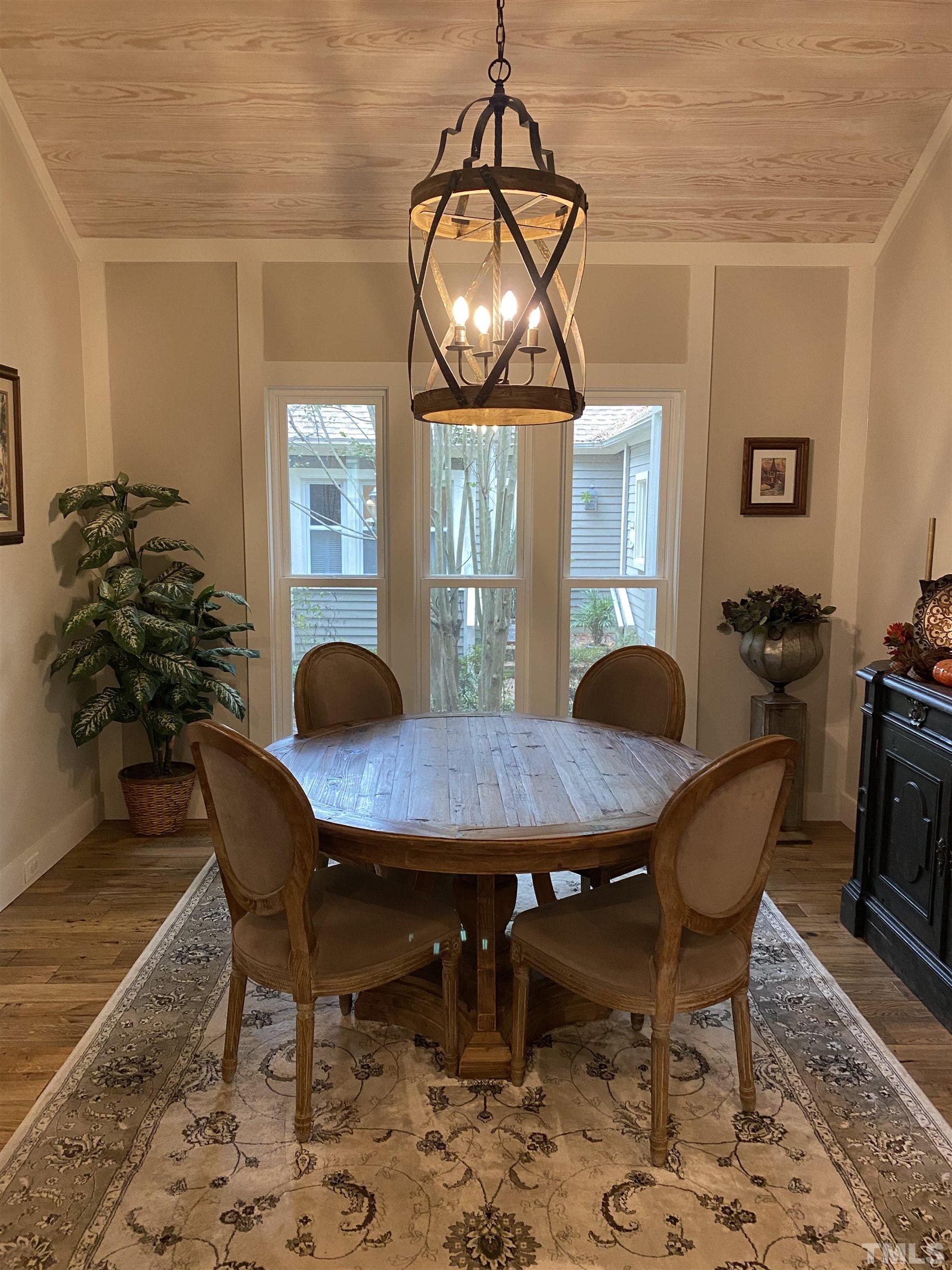 5811 Sentinel Drive Raleigh, NC 27609 - Photo 5 of 20 a view of a dining room with furniture window and wooden floor