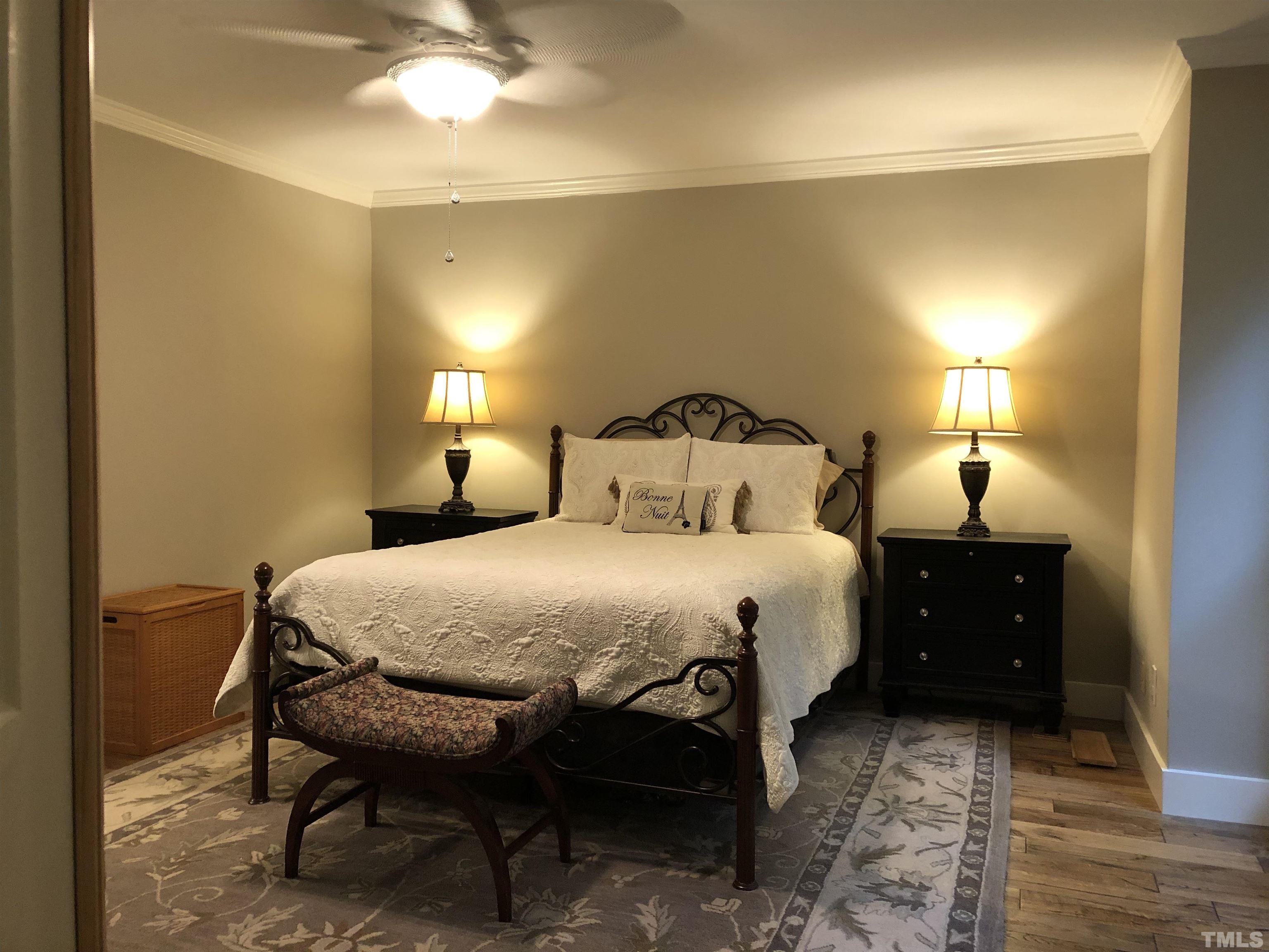 5811 Sentinel Drive Raleigh, NC 27609 - Photo 7 of 20 a bedroom with a bed and a lamp