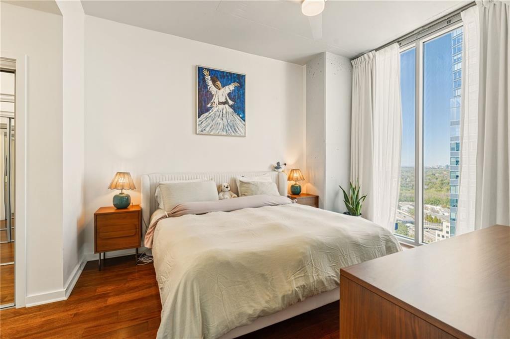 3324 Peachtree Road Northeast, Unit 2705 Atlanta, GA 30326 - Photo 23 of 68 a bedroom with a bed and a large window