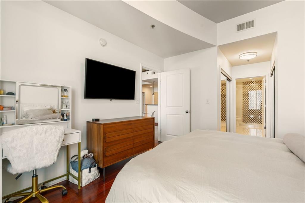 3324 Peachtree Road Northeast, Unit 2705 Atlanta, GA 30326 - Photo 24 of 68 a bedroom with a bed and a flat screen tv