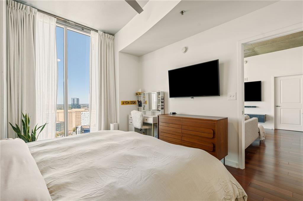 3324 Peachtree Road Northeast, Unit 2705 Atlanta, GA 30326 - Photo 25 of 68 a bedroom with a bed and a flat screen tv