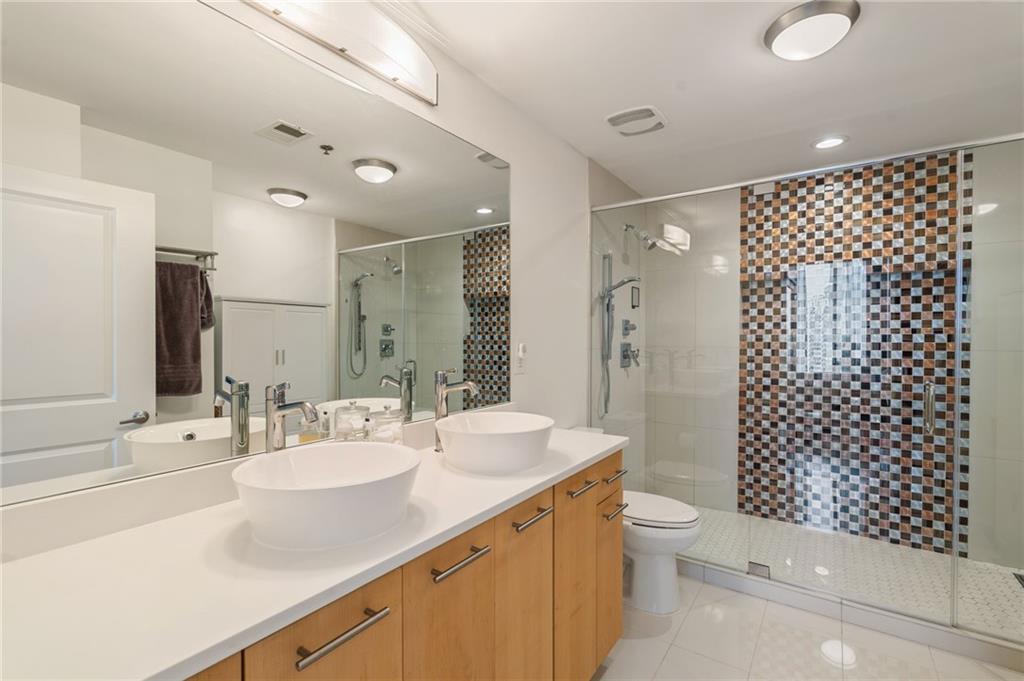 3324 Peachtree Road Northeast, Unit 2705 Atlanta, GA 30326 - Photo 27 of 68 a bathroom with a double vanity sink toilet and shower