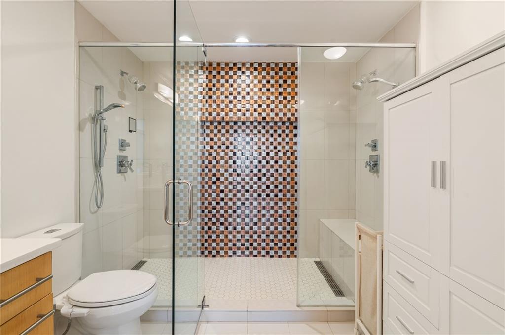 3324 Peachtree Road Northeast, Unit 2705 Atlanta, GA 30326 - Photo 29 of 68 a bathroom with a shower toilet and sink